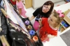 Henderson County High School senior Kati Rhoses guides a student in painting a butterfly.  Photo by Amy Wallot, May 11, 2015
