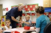 Custodian Marvin McHenry helps preschool students with a project in Rebecca Cales class at Heritage Elementary. Photo by Amy Wallot, Aug. 21, 2015