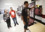 Senior Chauntey Gilmore places a ticket he received for positive behavior in the drop box in the main hallway at Madisonville North Hopkins High School (Hopkins County). Each week 10 tickets are drawn out of the box and the student names are read over the PA, the students receive a small prize and are thanked for making positive choices.  Photo by Amy Wallot, Oct. 16, 2014