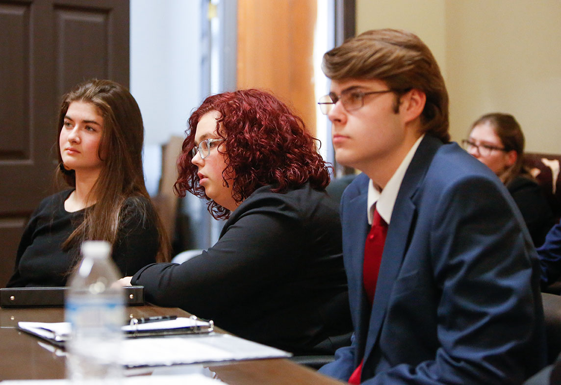 Ellie Cox, Zoee Robinson and Andrew Waters, left to right, listen to closing arguments from the defense table during a mock trial practice conducted by students from Jessamine Career and Technology Center (Jessamine County). Cox played the role of the defendant in the case, while Robinson and Waters were part of the defense team.Photo by Mike Marsee, Dec. 9, 2019