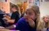 Charity Hammons, a student at Johnson Elementary School (Laurel County), chews on her pen while waiting for a book to be handed out to her during class. The school's library media specialist said she tries to make sure students have access to books they want to read. Photo by Bobby Ellis, Nov. 18, 2016