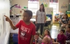 Jaden Curry, a 1st-grade student at Jody Richards Elementary School (Warren County), points out a light source on a Smart Board in Kara Northern's class. Northern is one of 50 teachers across the country testing digital media tools for STEM classrooms. Photo by Bobby Ellis, Oct. 17, 2016