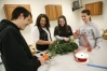 Sophomore Ryan Whitaker, sophomore Madison Stidham, junior Courtney Nash and sophomore Shelby Tracy construct a wreath during the floral design class at Anderson County High School.Photo by Amy Wallot, Jan. 28, 2010