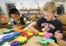 First-grade students Kebin Rosas and Blake Patton build a large gear pattern during Think Tank, a before school ESS program at Walnut HIll Elementary School (Casey County).Photo by Amy Wallot, Aug. 26, 2009