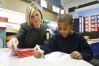 Venita Graves helps Damieon Mitchell write words with similar letters during kindergarten reading class at  Thomas Edison Elementary (Covington Independent).Photo by Amy Wallot, Dec. 8, 2008