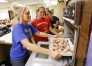 Livingston Central seniors Laken Johnson, Kayla Shull and Lindsey Manker place a pan in the oven filled with almond stuffed dates as part of a demonstartion in Rita Hosick's Foods class Oct. 9, 2007.  Oct. 9, 2007.
Photo by Amy Wallot