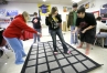 Junior Larissa Jude, junior Brett Preton, senior Nick, Bowen and senior Kevin Maymond help senior Andrea Bowen make her way through the carpet maze  during Marcie Hanson's Jobs for Kentucky Graduates class at Sheldon Clark High School (Martin) Dec. 16, 2009. During the carpet maze activity they must find a set path through the squares with out speaking to each other. Other students were working on brain teasers.
Photo by Amy Wallot