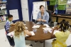 Abigail Bemiss claps out the syllables of the word rainbow with 1st-grade students. Photo by Amy Wallot, July 20, 2015