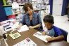 Reading recovery specialist Joni Griffin works with Criss Salas. Griffin worked with four students a day for 30 minutes each day during the camp.  Photo by Amy Wallot, July 20, 2015