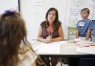 Literacy coach Anne Cochran guides 1st-grade student Abigail Coffey in an interactive writing activity.  Photo by Amy Wallot, July 20, 2015