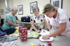 Puppeteer Mary Brown, center, helps Clay County High School adjunct professor Mary Stevens and Shearer Elementary School (Clark County) librarian Anne Hall create their own puppets. Photo by Amy Wallot, July 13, 2015