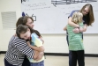 Madison Southern High School (Madison County) senior mentor Paige VanZandt hugs Ashley Wilson and senior Sierra Lainhart hugs Kendall Sumner at the end of their last meeting together at Silver Creek Elementary School (Madison County). Photo by Amy Wallot, May 8, 2012