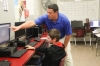 Jason Spalding, an instructor at Marion County Area Technology Center, makes a point to 8th-grade student Logan Pritchard, who is in the computer-aided design/computer-aided manufacturing rotation. Students also have rotations in welding, machine tool technology and industrial maintenance as part of the class that introduces them to the school's advanced manufacturing pathway. Photo by Megan Gross, Oct. 15, 2018