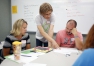 Northern Kentucky University associate professor Aimee Krug, center, helps Beechwood Elementary (Beechwood Independent) teachers Heather Dickman and Eric Fangman solve a problem. Photo by Amy Wallot, July 20, 2015