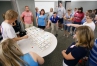 Highlands Middle School (Fort Thomas Independent) teacher Aaron Lense, center, inquires about using the game Set to explain four dimensions to his students. Photo by Amy Wallot, July 20, 2015