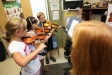 Fourth-grade students Natalie Peyton, Tina Zhang and Cormac O\'Brien practice the violin and viola with Christina Hartke Towell at McBrayer Elementary School (Rowan County). Photo by Amy Wallot, Aug. 17, 2012