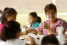Madison County Schools migrant education advocate Rona Comley has lunch with students.  Photo by Amy Wallot, June 23, 2015