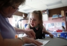 Teaching assistant Pam Young helps preschool student Braylee Roberts color a picture of a cat during class in Owen County. Photo by Amy Wallot, March 12, 2015