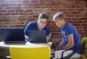 Computer science facilitator Mark Moore researches photo editing software with freshman Zachary Martin.  Photo by Amy Wallot, Aug. 24 , 2015