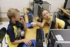 Haley Withrow, right, helps Billy Hardin log on to a website during Shannon Hill's 4th-grade class at Owingsville Elementary School (Bath County). Photo by Amy Wallot, May 17, 2013