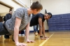 Seniors Mike Fifer and and Jaquan Evans do push-ups as part of the fitness scavenger hunt at Lloyd High School (Erlanger-Elsmere Independent). Photo by Amy Wallot, Feb. 24, 2015