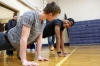 Seniors Mike Fifer and and Jaquan Evans do push-ups as part of the fitness scavenger hunt at Lloyd High School (Erlanger-Elsmere Independent). Photo by Amy Wallot, Feb. 24, 2015