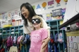 Japanese teacher Miko Momozono laughs with kindergarten student Abby Hutchison as she places a blindfold on her to play a directional game at Picadome Elementary School (Fayette County). Photo by Amy Wallot
