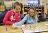 Lauren Bowling and Skylar Johnson use a Candy Land board to play a game about figurative language during Francis Hackney\'s language arts class at Porter Elementary School (Johnson County). Photo by Amy Wallot, Nov. 16, 2012