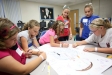Cheyene Hensley, Emily Simpson, Railey Daulton, Shelby Brown and Kayla Gibson draw a picture of their vice-principal while discussing qualities that make a positive role model during the Pulaski Elementary School anti-bullying program for 5th-grade students. Photo by Amy Wallot, Aug 24, 2012