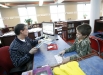 Library media specialist Barry Sanders checks out a book for 2nd-grade student Jacob Kubeny at Richardsville Elementary School (Warren County). The library is filled with natural light. Photo by Amy Wallot, March 2011