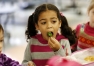 Kindergarten student Kayla Chambers-Reed tries a kale chip during the taste test at Rosa Parks Elementary School (Fayette County). She liked it. Photo by Amy Wallot, Jan. 17, 2013