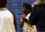 Second-grade student Aaliyah Crutcher claps along while square dancing. Photo by Amy Wallot, March 19, 2015