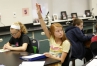 Arielle Martin raises her hand to answer a question about bacteria during Alicia Thomas\' class at Royal Spring Middle School (Scott County). Photo by Amy Wallot, Sept. 6, 2013