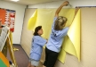 Salyersville Grade School (Magoffin County) teachers Michelle Whitaker and Angela Brickey decorate a bulletin board for a fellow teacher during a volunteer day at the temporary school. Photo by Amy Wallot, July 27, 2012