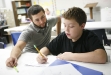 Math intervention specialist JP Poland helps 6th-grade student Dominick Lewis with long division at Monroe County Middle School. Photo by Amy Wallot, Sept. 13, 2011