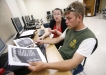 Noelle Barnes works with Travis Sloan on an English III assignment during the Diploma Recovery Academy at Shelby County High School. Sloan needed to work during the day to support his family and is getting his diploma for better job opportunities. Photo by Amy Wallot, April 25, 2012