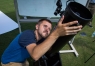 Austin Byrn helps his father Jeremy set up a telescope before the start of the solar eclipse. Photo by Bobby Ellis, Aug. 21, 2017