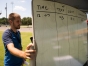 Austin Byrn, a student at Western Kentucky University, helps his father Jeremy Bryn, an environmental science teacher at Allen County Scottsville High School, set up a white board to write down data before the start of the solar eclipse. Photo by Bobby Ellis, Aug. 21, 2017