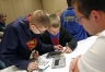 Geek Squad member Adam Rogers teaches Shelby County West Middle School 7th-grade students how to work on a tablet. Photo by Amy Wallot, March 26, 2015​