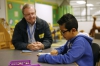 Every 1 Reads volunteer Rod Kincaid works with 3rd-grade student Oliver Chavez-Albarado in the library. Kincaid and his wife, a retired teacher, live in the neighborhood and volunteer at the school once a week.  Photo by Amy Wallot, Jan. 28, 2015