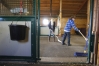 Caitlin Wade and Matthew DeRossett clean the barn after bringing a horse in for grooming at The STABLES (Fayette County). Photo by Amy Wallot, Nov. 28, 2012