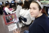 Eighth-grade student Sara Ammons added a picture of President Barack Obama visiting a family friend who had been injured in Afghanistan to her election scrapbook at T.K. Stone Middle School (Elizabethtown Independent). Photo by Amy Wallot, Oct. 19, 2012