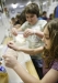 Fourth-grade students Miranda Clark, right, and Abby Applegate pull their freshly made ice cream out of ice buckets at the Mobile Science Activity Center at Tollesboro Elementary School (Lewis County). Students collected data from the activity and later made graphs to illustrate their findings. Photo by Amy Wallot; May 24, 2011