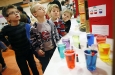 Second-grade students Zander Jones, Logan Allphin, Nick Lucas and Anthony Wolford look over Jose Espicio\' s experiment about color and heat absorption during the 8th-grade science fair at Williamstown Junior High School (Williamstown Ind.) Jan. 18, 2012. Photo by Amy Wallot