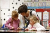 Amy Orberson helps 2nd-grade students Sarah Boyd and Addie Cross match three-digit numbers to visual representations of the numbers during her class at Woodlawn Elementary School (Boyle County).Photo by Amy Wallot, Dec. 2, 2014