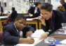 Melanie Trowel helps 7th-grade student Dorian Cleveland during class at Carter G. Woodson Academy (Fayette County). Photo by Amy Wallot, Nov. 6, 2013