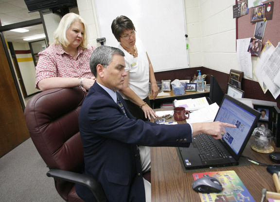 Benny Lile reviews tips in Google Docs with technology resource teachers Melissa Moss, left, and Valerie Stokes at Barren County High School April 22, 2010. “By being a forward-looking technology director, he allows us, teachers, students and others around him to explore the different avenues of technology that will enhance the educational experiences of the students in our district,” Moss said. Photo by Amy Wallot