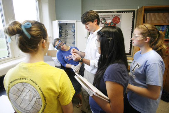 Biology teacher Jon Ezzell helps (pictured left to right) freshmen Hannah Moore, Emily Flener, Mariah Lanoire and Darah Doss with an experiment analyzing DNA during Principles of the Biomedical Sciences class at Muhlenberg County High School May 20, 2010. Muhlenberg County High is one of several Kentucky schools implementing the Project Lead the Way (PLTW) Biomedical Sciences pathway for their students. Photo by Amy Wallot