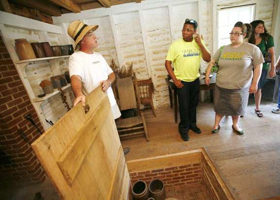 Terry and Sarah Hodges listen to tour guide Frank Webster, left, talk about the standalone kitchen at Riverside, the Farnsley-Moremen Landing, during the Project Archaeology workshop in Louisville June 22, 2010. Terry Hodges is a kindergarten assistant at Tully Elementary School (Jefferson County), and Sarah Hodges is a 3rd-grade teacher at Greenwood Elementary School (Jefferson County). Photo by Amy Wallot