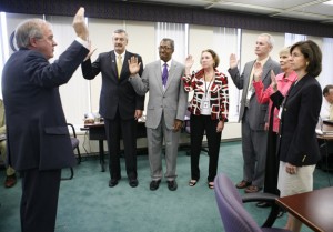Justice Daniel Venters swears in new and reappointed members of the Kentucky Board of Education on Aug. 4, 2010. Pictured left to right are Roger Marcum, William Twyman, Martha Jones, Jonathan “Jay” Parrent, Judith Gibbons and Mary Gwen Wheeler. Photo by Amy Wallot
